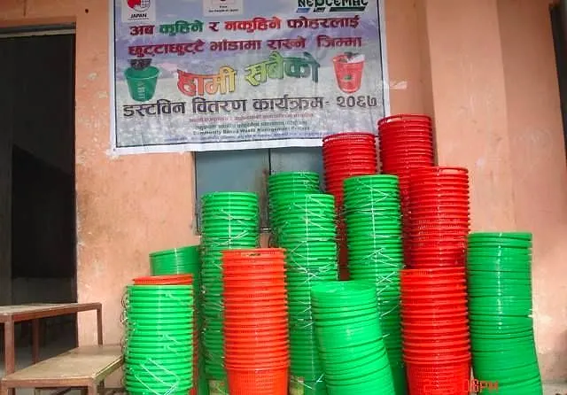 Buckets stacked outside a ward office before distribution